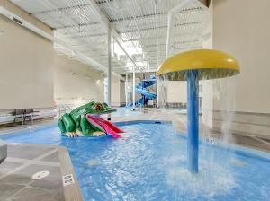 a pool with a inflatable frog in the water at Outstanding Mountain Condo *WATERSLIDE* HOTTUB* hosted by Fenwick Vacation Rentals in Canmore