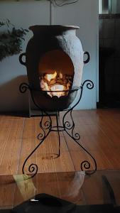 a fire pit sitting on top of a wooden floor at APARMENT SAMANA HOUSE OLLANTAYTAMBO in Ollantaytambo