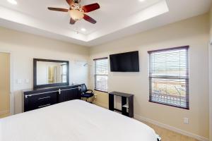 a bedroom with a bed and a ceiling fan at Harbor Island Retreat in Port Isabel