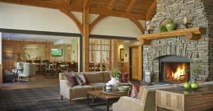 una sala de estar con una gran chimenea de piedra. en Green Mountain Suites Hotel, en Burlington