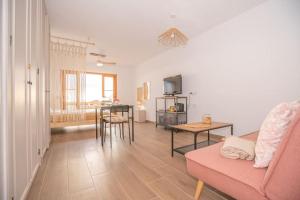 a living room with a couch and a table at Port Royale Los Cristianos Arona in Los Cristianos