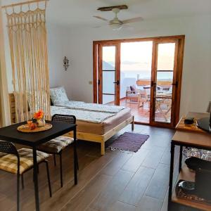 a living room with a bed and a table at Port Royale Los Cristianos Arona in Los Cristianos