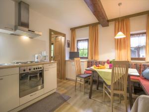a kitchen and dining room with a table and chairs at Apartment in Top Location in F gen with Balcony in Fügen