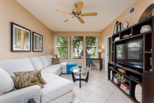 a living room with a white couch and a tv at Scottsdale Condo in Scottsdale