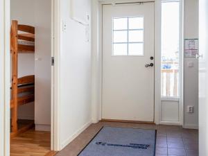 a hallway with a white door and a rug at 8 person holiday home in LOFSDALEN in Lofsdalen