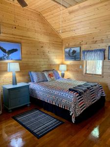 a bedroom with a bed in a log cabin at Clam Gulch Lodge in Clam Gulch
