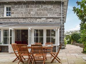 a patio with a wooden table and chairs at Castle View - Ukc5701 in Castletown