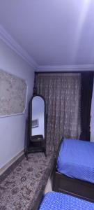 a mirror and a bed in a small room at lovely 3 bedroom apartment with 2 balconies and a hot tub in Cairo