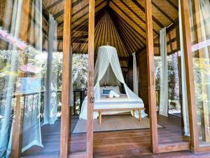 a hammock on the porch of a tree house at ONAYA Bali Resort - Adults Only in Uluwatu