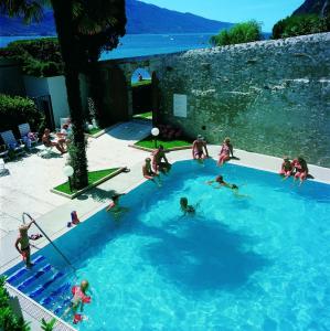 a group of people playing in a swimming pool at Residence San Luigi in Limone sul Garda