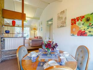 a dining room with a wooden table and chairs at Hall Farm Bungalow in Shirley