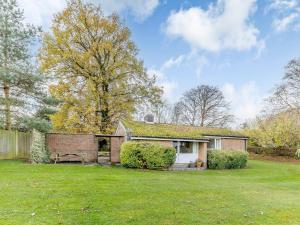 a house in a yard with a grass field at Hall Farm Bungalow in Shirley