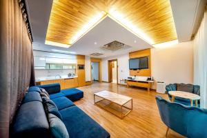 a living room with a blue couch and a table at HS Tourist Hotel in Yeosu