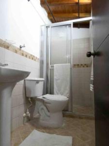 een badkamer met een toilet, een douche en een wastafel bij Vamos para Bello Antioquia in Bello