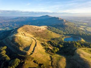an aerial view of a mountain with a lake at The Bothy in Malvern Wells