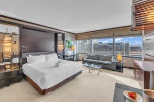 a bedroom with a large bed and a living room at VDARA Beautiful suite on 22nd FLR Free Valet parking in Las Vegas