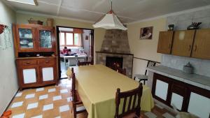 a kitchen with a table and a fireplace at El viejo boliche in Trevelin