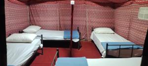 a room with three beds in a tent at Panorama Camp Bidiya in Al Wāşil +36 photos