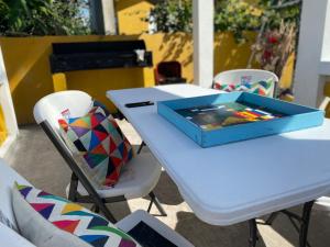 a white table with a blue box on top of it at PARADISE VILLa 2 PRIVATE POOL in Ocho Rios