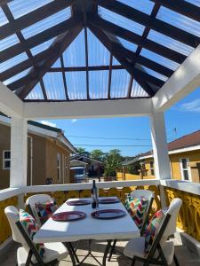 a white table and chairs on a patio at PARADISE VILLa 2 PRIVATE POOL in Ocho Rios