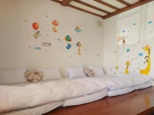 a large white couch in a room with balloons on the wall at SunRise 23.5N B&B in Fenchihu