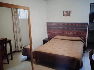 Ένα ή περισσότερα κρεβάτια σε δωμάτιο στο Hotel Estación Central