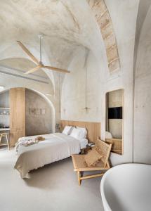 a bedroom with a large bed and a bath tub at Melisende in ‘Akko