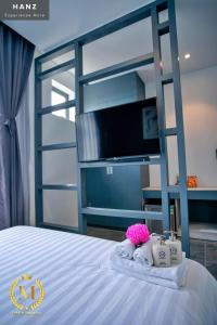 a bedroom with a bed with a bunk bed with a tv at HANZ Mina Hotel in Ấp Long Khánh