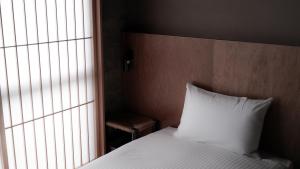 Letto o letti in una camera di deigo ISHIGAKI ｜沖縄石垣島の一棟貸し別荘［泥娯］