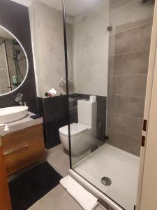 a bathroom with a toilet and a sink and a shower at Luxus Apartment über den Dächern vom Allgäu in Sonthofen