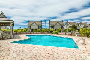 a swimming pool in front of a house at Beach Blessings in Topsail Beach