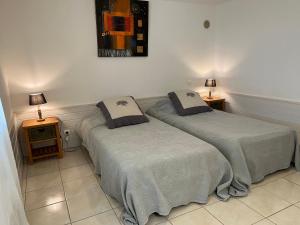 two beds sitting next to each other in a room at Lou Souleu in Riez