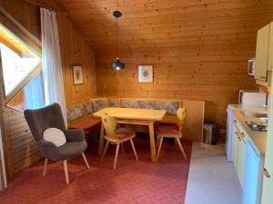 a kitchen with a table and chairs in a room at Ferienhaus am Burgsee in Ladis