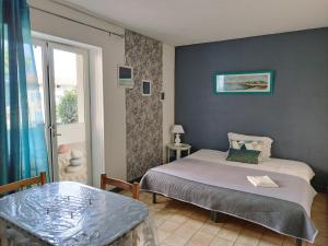 Ένα ή περισσότερα κρεβάτια σε δωμάτιο στο Hôtel Studios Les Acacias +35 φωτογραφίες