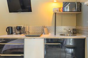 a kitchen with a counter top with a sink at L'Eclose in Le Guilvinec