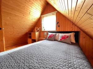 ブワディスワボボにあるDomki Letniskowe Ediのベッドルーム1室(屋根裏部屋に大型ベッド1台付)