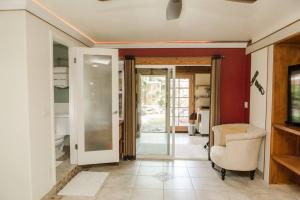 a living room with a chair and a sliding glass door at Pahoa Paradise Palms in Pahoa
