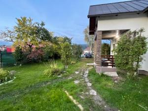 a view of a house with a path leading to the door at Casa Helen Insurance&Tourism in Gălăuţaş