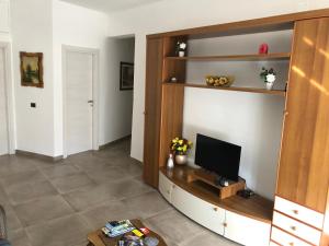 a living room with a flat screen tv on a shelf at La Casa di Antonella in Agrigento