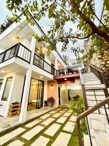 an image of a house with a staircase in front of it at Dalat Topview Homestay in Da Lat