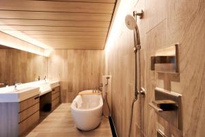 a bathroom with a toilet and two sinks and a shower at The Tower Hotel Nagoya in Nagoya