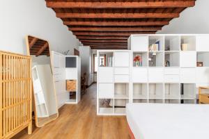 a room with white shelves and a wooden ceiling at Italian Experience-Uriel Suite Apartment in Corteolona