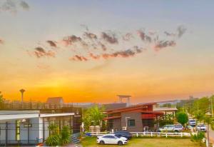 a building with cars parked in a parking lot at Vanilla Sky @Khao Yai in Ban Bung Toei