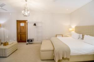 sypialnia z dużym białym łóżkiem i drabiną w obiekcie Harbour House Hotel - Adventure Pads w mieście Hermanus