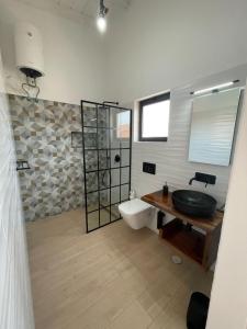 a bathroom with a sink and a toilet at New Rooftop Penthouse with Oceanview in Santa Maria