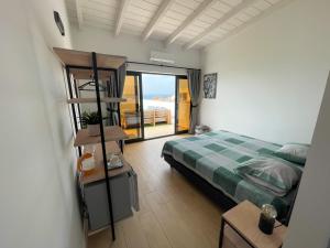 a bedroom with a bed and a view of the ocean at New Rooftop Penthouse with Oceanview in Santa Maria