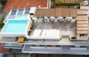 an overhead view of a house with a swimming pool at ThalaSEA Apartments in Chrani