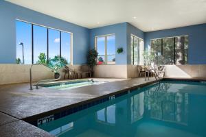a swimming pool in a house with blue walls at Days Inn & Suites by Wyndham East Flagstaff in Flagstaff