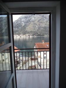 a view of a lake from a window at Chic sea front apartment with breathtaking Kotor Bay view in Donji Stoliv