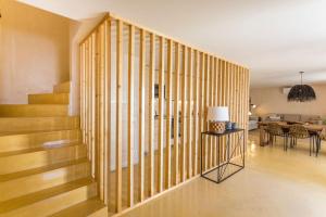 a wooden staircase in a living room with a table at Sea'Ya Thoughtful Stays - Villas in Cascais